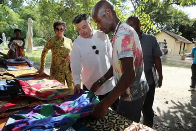 Sculptor Dominic Benhura (right) shows international designer Manuel Fernandez (centre) some outfits on display at Dominic Studio