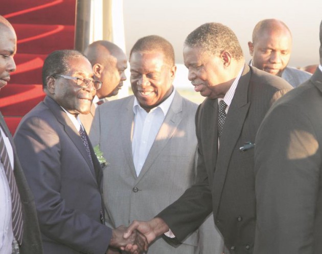 President Mugabe greets Vice President Phelekezela Mphoko while Vice President Emmerson Mnangagwa (centre) looks on shortly after landing at Harare International Airport from the African Union 26th Ordinary Summit in Addis Ababa, Ethiopia, yesterday. - Picture by Justin Mutenda.