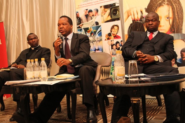 RBZ governor Dr John Mangudya (centre) stresses a point at the Archdiocese of Harare Social Communications business breakfast meeting yesterday while Barclays Bank of Zimbabwe MD George Guvamatanga and Father Kenneth Muguti (left) listen attentively
