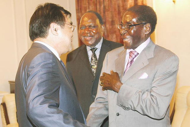 President Mugabe shares a lighter moment with Deputy Secretary-General of The National Development and Reform Commission from China Mr Fan Hengshan at State House in Harare yesterday, while Chief Secretary to the President and Cabinet Dr Misheck Sibanda looks on. — (Picture by Munyaradzi Chamalimba)