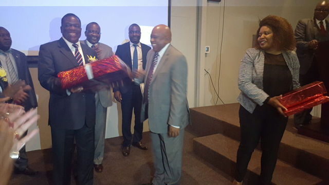 VP Mnangagwa receives a token of appreciation from Zimpapers Board Chair Mr Lupepe and Herald Business Editor Happiness Zengeni.