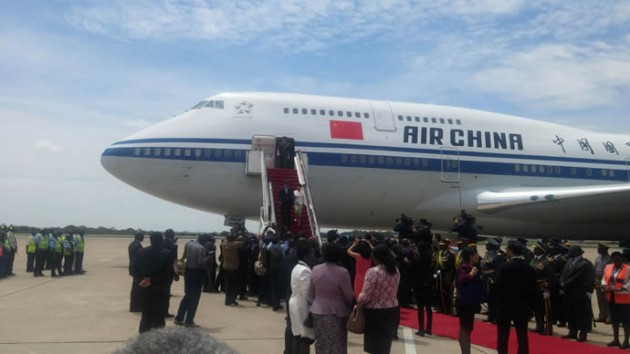 President Xi and wife disembark from the plane