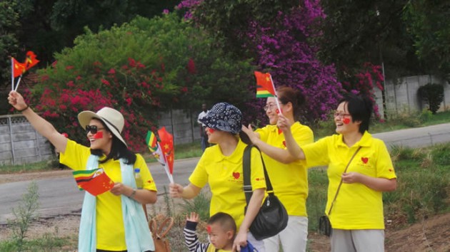 Chinese nationals wave the Zimbabwe and Chinese flags today