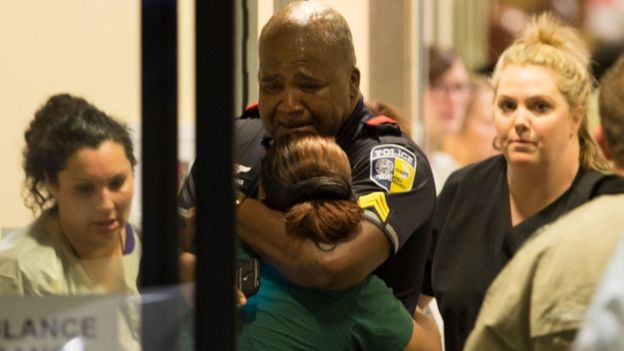A transport police officer comforts a relative at Baylor University Hospital