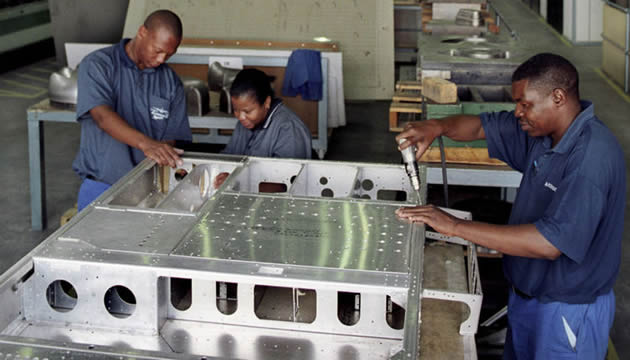 Workmen go about their duties at a factory in South Africa . — Picture by AMO/ Graeme Williams