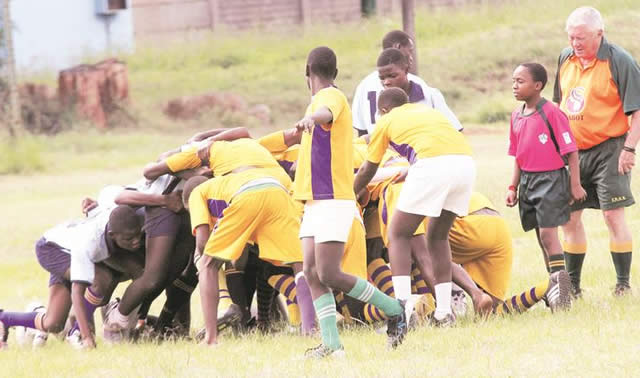 BIG DREAMS . . . Young referee Anotida Chilundu (second from right) monitors a scrum situation shadowing veteran referee, Dave Mathews, yesterday during Glen View 2’s 5-0 win over Kuwadzana 1. — (Picture by Innocent Makawa)