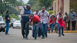 Civilians who had been hiding inside during gunbattles manage to flee from the Westgate Mall in Nairobi, Kenya Saturday, Sept. 21, 2013-AP