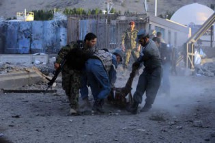 Afghanistan: Afghan security forces lift the dead body of their colleague during an attack on the US consulate in Herat on September 13, 2013. Gunmen staged an attack on the US consulate in Herat, western Afghanistan leaving at least one person dead and 18 wounded, officials said. Four policemen were among the wounded, Herat hospital spokesman Mohammad Rafiq Sherzai said. – AFP.