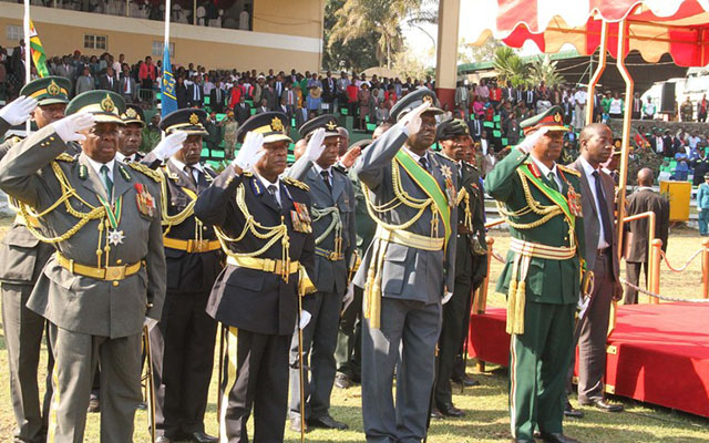 Service chiefs (from right) Zimbabwe National Army Commander Lieutenant-General Philip Valerio Sibanda, Air Force of Zimbabwe Commander Air Marshal Perrance Shiri, Zimbabwe Republic Police Commissioner-General Augustine Chihuri, Zimbabwe Prisons and Correctional Services Commissioner-General Retired Major-General Paradzai Zimondi salute during the singing of the National Anthem at the Harare Agricultural Show yesterday. - (Picture by Shelton Muchena)