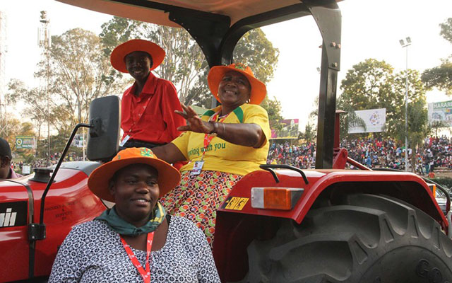 Mrs Irene Musakwa (in yellow) of Murehwa gets a feel of the tractor she won for being the overall best exhibitor at the Harare Agricultural Show yesterday. - (Picture by Tawanda Mudimu)