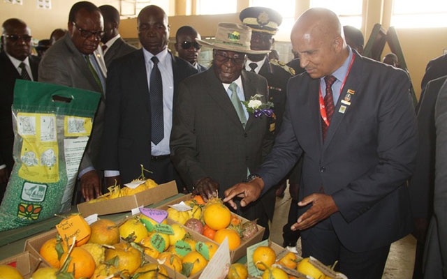 President Mugabe is taken on a tour of small-scale farmers’ stands by deputy president of the Zimbabwe Show Society Ivan Craig. Looking on is Agriculture, Mechanisation and Irrigation Development Minister Dr Joseph Made at the Harare Agricultural Show yesterday