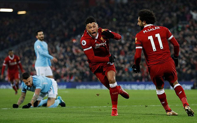 Twenty-four-year-old Alex Oxlade-Chamberlain runs away to the Anfield faithful after seeing the ball hit the back of the net as Mo Salah beams at the goal