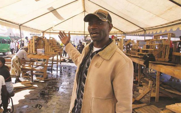 Grassroots Vendors Association chairman Mr Alexio Mudzengerere assessing the destruction caused by opposition supporters during their demonstrations last week.