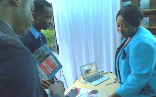 An exhibitor shows visitors some books at ZIBF 2016