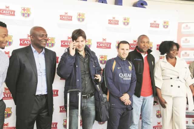 HERE COMES TIKI-TAKA . . . Barcelona Football School coaches Isaac Oriol Guerrero Hernandez (second from left) and Daniel Bigas Alsina pose for a photo with Delta marketing executive Stanley Muchenje (left), SABMiller Africa premium brands manager David Minja (second from right) and Delta Beverages marketing manager Patricia Murambinda (right) after the arrival of the coaches at the Harare International Airport yesterday