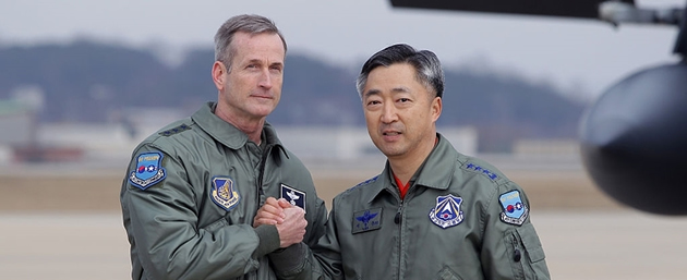 US Lieutenant General Terrence J. O’Shaughnessy (left) deputy Commander of the US Forces Korea shakes hands with Lee Wang-Geun (right) commander at South Korea’s Air Force Operations during a Press briefing on the flight by a US B-52 Stratofortress over South Korea at the Osan Air Base