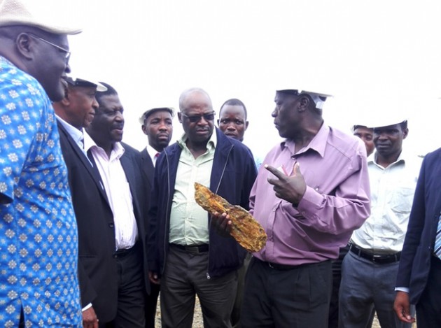 Dorowa Minerals Operations Manager Mr Chitata (second from right) shows Industry and Commerce Mike Bimha (third from left) magnetite ore at Dorowa Minerals last week. Looking on is IDC Zimbabwe chairman Mr Herbert Nkala (fourth from left), general manager Mr Mike Ndudzo (left), Chemplex chief executive Mr Misheck Kachere (second from left) and other company executives