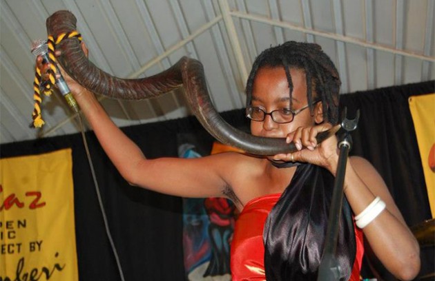 A Blackheat instrumentalist plays a traditional horn