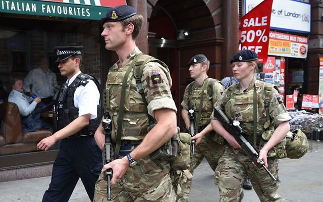 British soldiers patrol in Manchester after a terrorist attack earlier this week