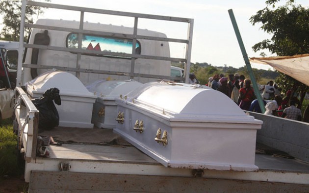 Caskets bearing the bodies of four members of the Jokomela family arrive at their residence in Budiriro yesterday awaiting burial today. — Picture by Shelton Muchena