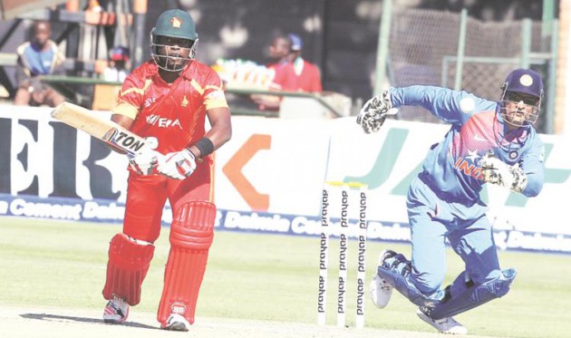 MASTER BLASTER . . . Zimbabwe all-rounder Elton Chigumbura works the ball under the close attention of Indian skipper MS Dhoni in the first Twenty20 International at Harare Sports Club on Saturday. - AFP