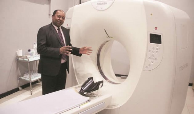 Chitungwiza Hospital CEO Dr Obadiah Moyo shows the ct Scan that is used by patients at the hospital yesterday