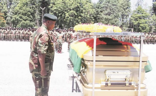 Zimbabwe Defence Forces Commander General Constantine Chiwenga salutes after laying a batch of flowers on the casket bearing the body of Retired Brigadier-General Jimmy Mhandu at a funeral parade held at One Commando Regiment in Harare yesterday. — (Picture by Kudakwashe Hunda)