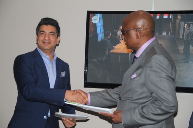 MOVING MOUNTAINS . . . ZIFA president Philip Chiyangwa (right) and Total Sports Marketing chief executive Moinul Chowdury exchange documents after the signing of their mega deal in Harare last night