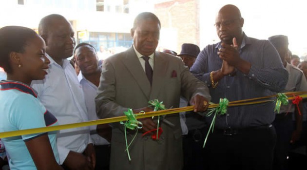 Choppies Zimbabwe chairman Ambassador Phelekezela Mphoko cuts the ribbon at the opening of the retail chain’s first store in Harare last week. The store is located along Harare Street. - (Picture by Innocent Makawa)