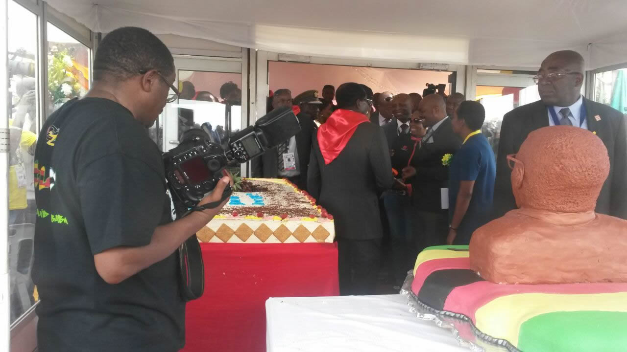 A photographer prepares to capture President Mugabe cutting his birthday cake at Elephant Hills hotel during the 21st February Movement celebrations to celebrate the life of Zimbabwe's Head of State.