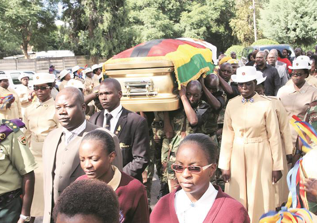 ZNA pallbearers carry the casket bearing the body of national heroine Cde Vivian Mwashita as it arrived for a funeral service at Citadel Salvation Army church in Braeside, Harare, yesterday. — (Picture by Munyaradzi Chamalimba)