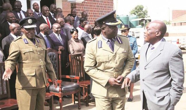 Police Commissioner-General Augustine Chihuri (right) chats with ZRP Staff College principal Senior Assistant Commissioner Wonder Tembo while Deputy Commissioner-General Levy Sibanda (left) looks on at the official opening of the Assistant Commissioners’ Seminar in Harare yesterday. - (Picture by Justin Mutenda)