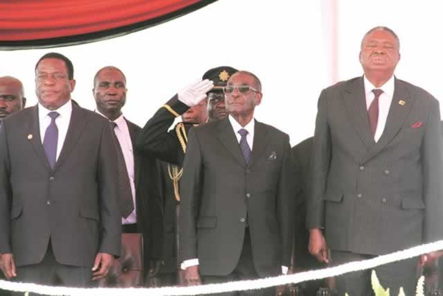 President Mugabe and his deputies Cdes Emmerson Mnangagwa and Phelekezela Mphoko stand at attention during the singing of the National Anthem at the National Heroes Acre yesterday