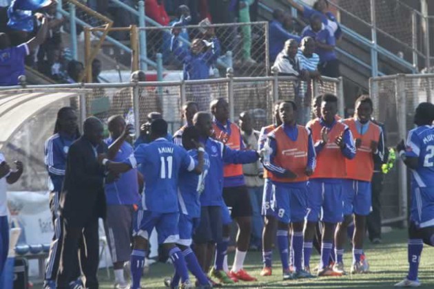 TOGETHER AS ONE . . .  Dynamos players Qadr Amini (left) and Ronald Chitiyo embrace their coach David Mandigora as they celebrate the former’s goal at Rufaro yesterday 