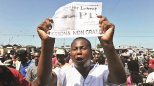 This file photo shows anti-government demonstrators marching in the streets of Port-au-Prince on October 14, 2012.— Press TV