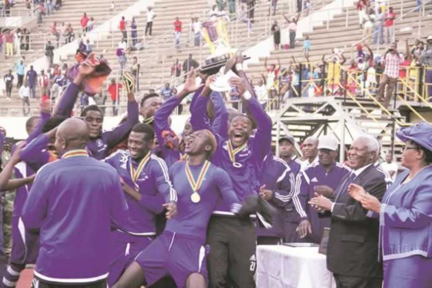 HAPPY HOUR . . . Jubilant Dynamos players lift the Defence Forces trophy while the Minister of Defence Sydney Sekeramayi looks on at the National Sports Stadium on Tuesday. — (Picture by Tawanda Mudimu)