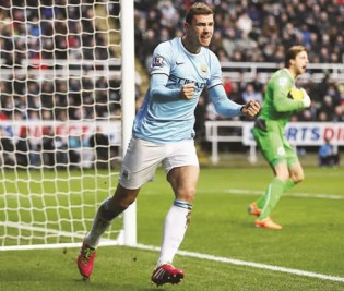 CELEBRATION TIME . . . Manchester City striker Edin Dzeko celebrates after scoring the opening goal during the English Premier League football match between Newcastle United and Manchester City at St James’ Park in Newcastle yesterday. — AFP