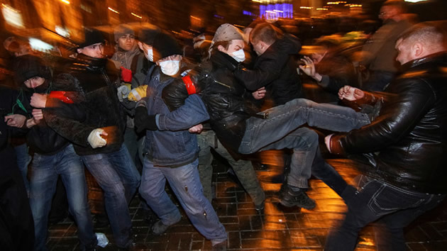 Participants of an anti-war rally (L) clash with a pro-Russian supporter during their respective rallies in Donetsk on March 13, 2014. – Reuters.