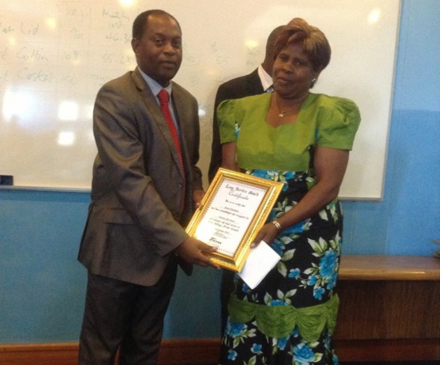 Doves Holdings’ stores controller Mrs Elizabeth Godo (right) receives her long service award from Doves Funeral Assurance managing director Mr Talent Maziwisa during a long service award ceremony held last week 