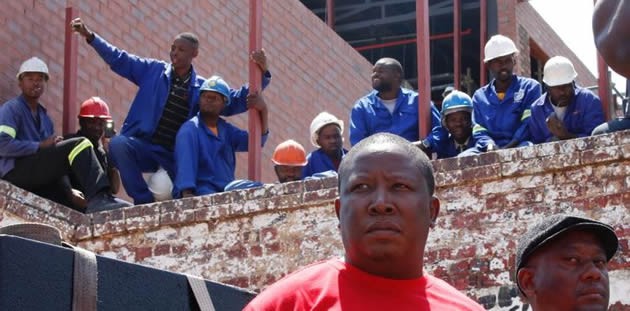 Economic Freedom Fighters leader Julius Malema (centre) waits to address supporters before a march to the constitutional court in Johannesburg on Tuesday. — Picture by Sydney Seshibedi/Reuters