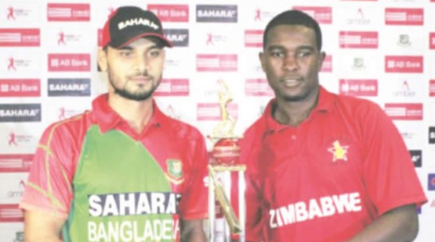 THE TROPHY IS MINE . . . Zimbabwe limited overs skipper Elton Chigumbura (right) and his Bangladesh counterpart, Mashrafe Mortaza, pose for a photo with the ODI trophy that their teams will fight for — AFP