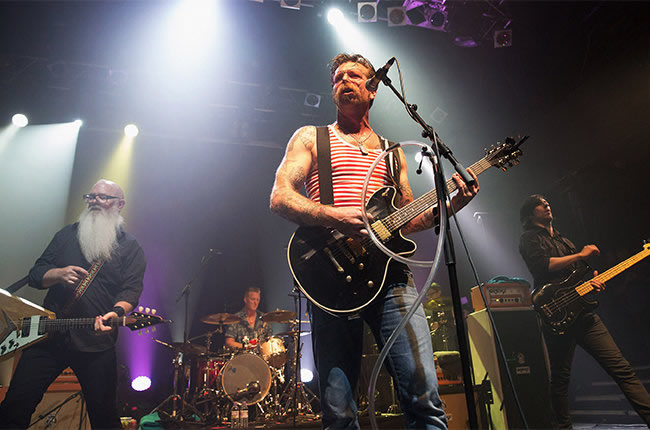 Dave Catching, Josh Homme, Jesse Hughes and Joe Grimshaw of Eagles of Death Metal perform on stage at KOKO on June 17 2015 in London. - Getty Images