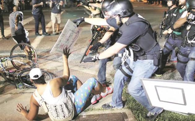 Police officers arrest a demonstrator in Ferguson, in Missouri recently