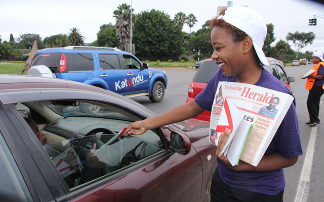 Shalom Charamba distributes fliers to motorists during the belated International Women’s Day commemorations