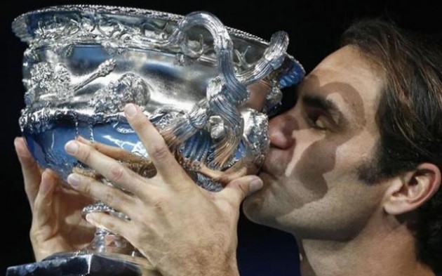 FEDEXPRESS . . . Roger Federer kisses the trophy after winning the men’s singles final against Spain’s Rafael Nadal at the Australian Open yesterday. Federer shrugged off a decade of Grand Slam heartbreak against Nadal in a classic Australian Open tennis final to capture his 18th major title in Melbourne