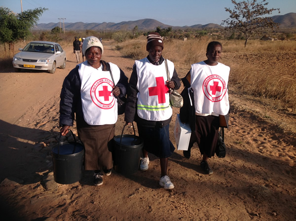 EALIER DURING THE DAY: First Aid volunteers walking back from Kaitano Primary School Polling Station in Mudzi West where they were attending to voters who were on the queue who needed assistance