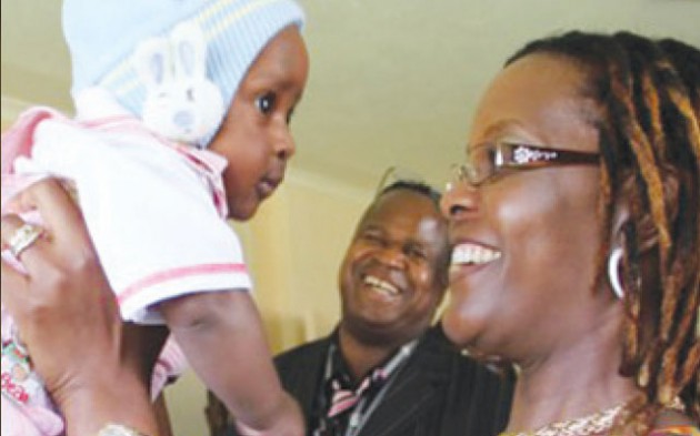 First Lady Amai Grace Mugabe holds baby Dexter during a tour of Amai Mugabe Children’s Home with a UNWTO delegation in Mazowe
