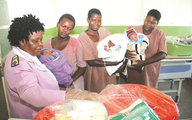 Bundles of joy . . . Harare Hospital mternity matron Sister Dade Getrude Pedzisai opens one of the baby wear hampers donated to babies born on New Year’s Day by the First Lady Auxillia Mnangagwa yesterday. Looking on (from left) are Mrs Panashe Madholo,Mrs Netsai Kazembe and Mrs Nyasha Mashanda holding their babies. - Picture by Kudakwashe Hunda