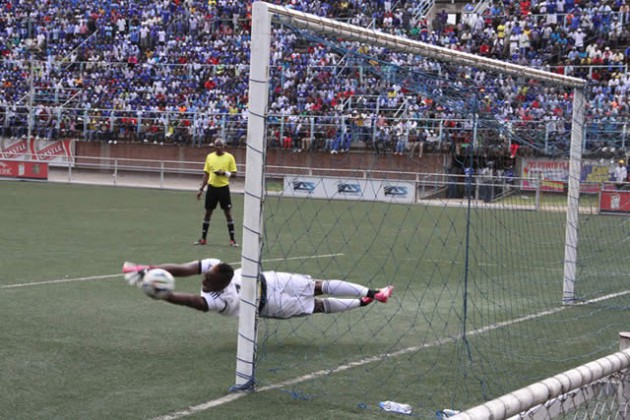 SUPER SAVER . . . Dynamos goalkeeper George Chigova dives to save Misheck Mburayi’s spot kick during the penalty shootout in yesterday’s Independence Cup semi-final match against Harare City at Rufaro. — Picture by William Mafunga