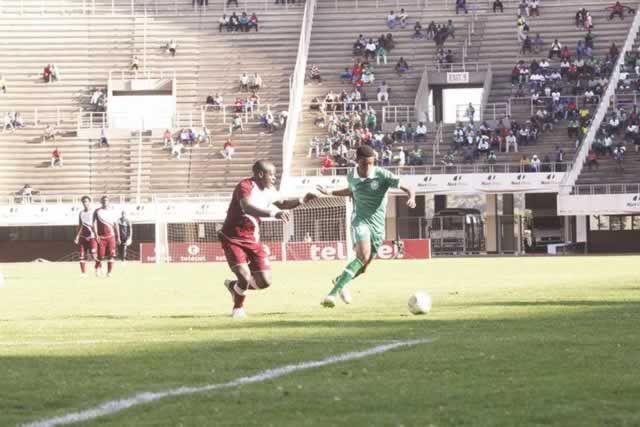DANGER IN THE HOUSE . . . CAPS United’s Gerald Phiri (right) finds his way past Shabanie Mine defender Godknows Murirwa as he charges for goal during yesterday’s match at the National Sports Stadium